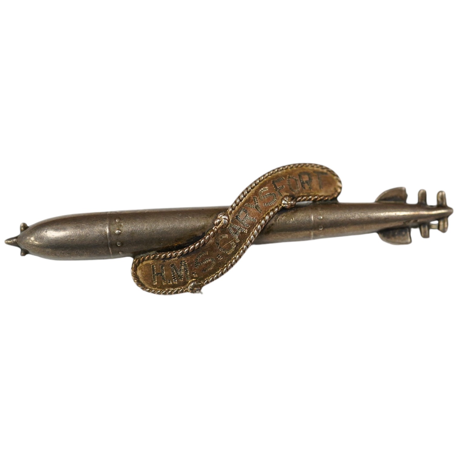 A WW1 silver sweethearts brooch from HMS Caryfort modelled as a torpedo